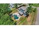 Aerial view showcases a beautiful backyard with a private pool, patio area, and lush landscaping at 101 Cross Current Ln, Belmont, NC 28012