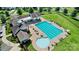 Aerial view of a clubhouse and pool with ample seating, tables and a kiddie pool at 101 Cross Current Ln, Belmont, NC 28012