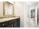 Stylish bathroom with a granite countertop, dark cabinetry, and a view into the adjoining living area at 101 Cross Current Ln, Belmont, NC 28012