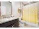 Bathroom with granite countertops, wood cabinetry, and a shower featuring a bright yellow curtain at 101 Cross Current Ln, Belmont, NC 28012