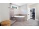 Bathroom featuring a tiled shower, a large soaking tub, and an adjoining walk-in closet at 101 Cross Current Ln, Belmont, NC 28012