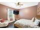 Cozy bedroom with hardwood floors, floral bedding, a mounted TV, and natural light at 101 Cross Current Ln, Belmont, NC 28012