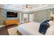 Bedroom boasting patterned wallpaper, hardwood floors, and a TV for comfortable viewing at 101 Cross Current Ln, Belmont, NC 28012
