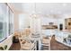 Dining area with a chandelier and view of the modern kitchen with white cabinetry at 101 Cross Current Ln, Belmont, NC 28012
