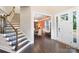 Inviting foyer with hardwood floors, staircase, and a view into the dining room with lovely wall paper at 101 Cross Current Ln, Belmont, NC 28012