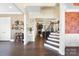 Spacious foyer with hardwood floors, staircase and view of living room with stone fireplace at 101 Cross Current Ln, Belmont, NC 28012