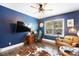 This home office features navy walls, hardwood flooring, and a large window for natural light at 101 Cross Current Ln, Belmont, NC 28012