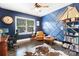 Stylish home office featuring navy walls, built-in shelves, and a comfortable seating area at 101 Cross Current Ln, Belmont, NC 28012