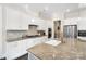 A modern kitchen with white cabinets, granite countertops, and stainless steel appliances at 101 Cross Current Ln, Belmont, NC 28012