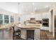 Bright and airy kitchen featuring a large island with seating and modern stainless steel appliances at 101 Cross Current Ln, Belmont, NC 28012