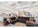 Spacious living room with coffered ceilings, a large sectional sofa, and stairs to the second floor at 101 Cross Current Ln, Belmont, NC 28012