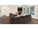 A cozy living room featuring a stone fireplace, large TV, and comfortable seating at 101 Cross Current Ln, Belmont, NC 28012