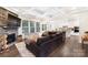 Open-concept living room featuring a stone fireplace, coffered ceilings, and views into the kitchen at 101 Cross Current Ln, Belmont, NC 28012