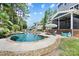 Inviting backyard pool with stone patio, outdoor dining area, and access to screened porch, ideal for relaxation and entertaining at 101 Cross Current Ln, Belmont, NC 28012