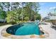 Beautiful backyard pool surrounded by lush landscaping and stone patio, perfect for enjoying the outdoors at 101 Cross Current Ln, Belmont, NC 28012