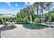 Backyard pool with stone patio surrounded by lush landscaping and mature trees at 101 Cross Current Ln, Belmont, NC 28012