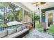 Relaxing screened porch with comfortable seating and a view of the backyard pool at 101 Cross Current Ln, Belmont, NC 28012