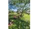 Serene backyard setting with comfortable seating under a large shade tree, ideal for relaxation at 111 Redwood Ln, Gastonia, NC 28052