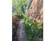 Beautifully landscaped walkway with flowers and greenery along the side of the home at 111 Redwood Ln, Gastonia, NC 28052