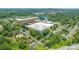 Expansive aerial view featuring residential areas, commercial buildings, and a recreational park at 1113 W 4Th Ave, Gastonia, NC 28052