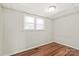 Bedroom featuring bright light and wood laminate flooring at 1113 W 4Th Ave, Gastonia, NC 28052