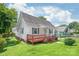 Charming one story home with a red porch and freshly cut lawn, perfect for enjoying a beautiful day at 1113 W 4Th Ave, Gastonia, NC 28052