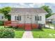 Inviting front exterior with walkway, freshly painted porch, and manicured lawn, ready to welcome you home at 1113 W 4Th Ave, Gastonia, NC 28052