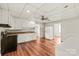Efficient kitchen featuring bright white cabinetry, laminate countertops, and hardwood flooring, ready for everyday cooking at 1113 W 4Th Ave, Gastonia, NC 28052
