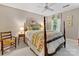 Cozy bedroom features a wooden four-poster bed with floral bedding and a bedside table with lamp at 1119 Holleybank Dr, Matthews, NC 28105