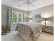 Inviting bedroom with neutral tones, patterned bedding, a rocking chair, and natural light from a large window at 1119 Holleybank Dr, Matthews, NC 28105
