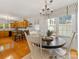Bright breakfast nook with hardwood floors, chandelier, and view to the kitchen at 1119 Holleybank Dr, Matthews, NC 28105