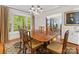 Bright dining room features hardwood floors, a large window, and chandelier lighting at 1119 Holleybank Dr, Matthews, NC 28105