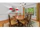 Elegant dining room with a large table, chandelier lighting, and a view of the outdoors at 1119 Holleybank Dr, Matthews, NC 28105