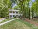 Traditional two-story home with black shutters, a manicured lawn, mature trees, and a private drive at 1119 Holleybank Dr, Matthews, NC 28105