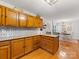 Spacious kitchen with wood cabinets, granite countertops, and a view into the dining area at 1119 Holleybank Dr, Matthews, NC 28105