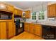 Kitchen with wood cabinets, granite countertops, and stainless steel appliances at 1119 Holleybank Dr, Matthews, NC 28105