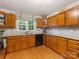 Kitchen with wood cabinets, granite countertops, and tile backsplash at 1119 Holleybank Dr, Matthews, NC 28105