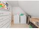 Well-lit laundry room with washer, dryer, and overhead shelving for storage solutions at 1119 Holleybank Dr, Matthews, NC 28105