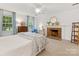Main bedroom with fireplace, soft carpet, and natural light at 1119 Holleybank Dr, Matthews, NC 28105