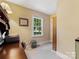 Bright home office with a wooden desk, neutral walls, and a window view of the outdoors at 1119 Holleybank Dr, Matthews, NC 28105