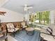 Relaxing screened porch with comfortable seating, ceiling fan, and serene views at 1119 Holleybank Dr, Matthews, NC 28105