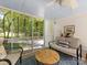 Cozy screened porch offers outdoor living space with comfortable seating and scenic backyard views at 1119 Holleybank Dr, Matthews, NC 28105