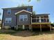 The backyard of this two-story home has a deck and stairs leading down to the yard at 112 Gilliatt St # 1, Shelby, NC 28150