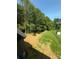 Large fenced backyard with a small storage shed surrounded by mature trees at 112 Gilliatt St # 1, Shelby, NC 28150