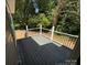 Back deck with black metal railings and wooded background at 112 Gilliatt St # 1, Shelby, NC 28150