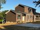 This two-story home features dark siding, black shutters, and a well manicured lawn at 112 Gilliatt St # 1, Shelby, NC 28150