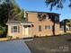 This two-story home features dark siding, black shutters, and a well manicured lawn at 112 Gilliatt St # 1, Shelby, NC 28150