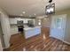 Open kitchen layout with stainless appliances and wood floors, seamlessly connects to the dining area at 112 Gilliatt St # 1, Shelby, NC 28150