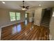 Spacious living room featuring beautiful hardwood floors, open layout, and stairs to the second floor at 112 Gilliatt St # 1, Shelby, NC 28150