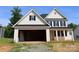 New construction home with white siding, black shutters, and an open garage ready for customization at 114 Still Creek Dr, Mooresville, NC 28115